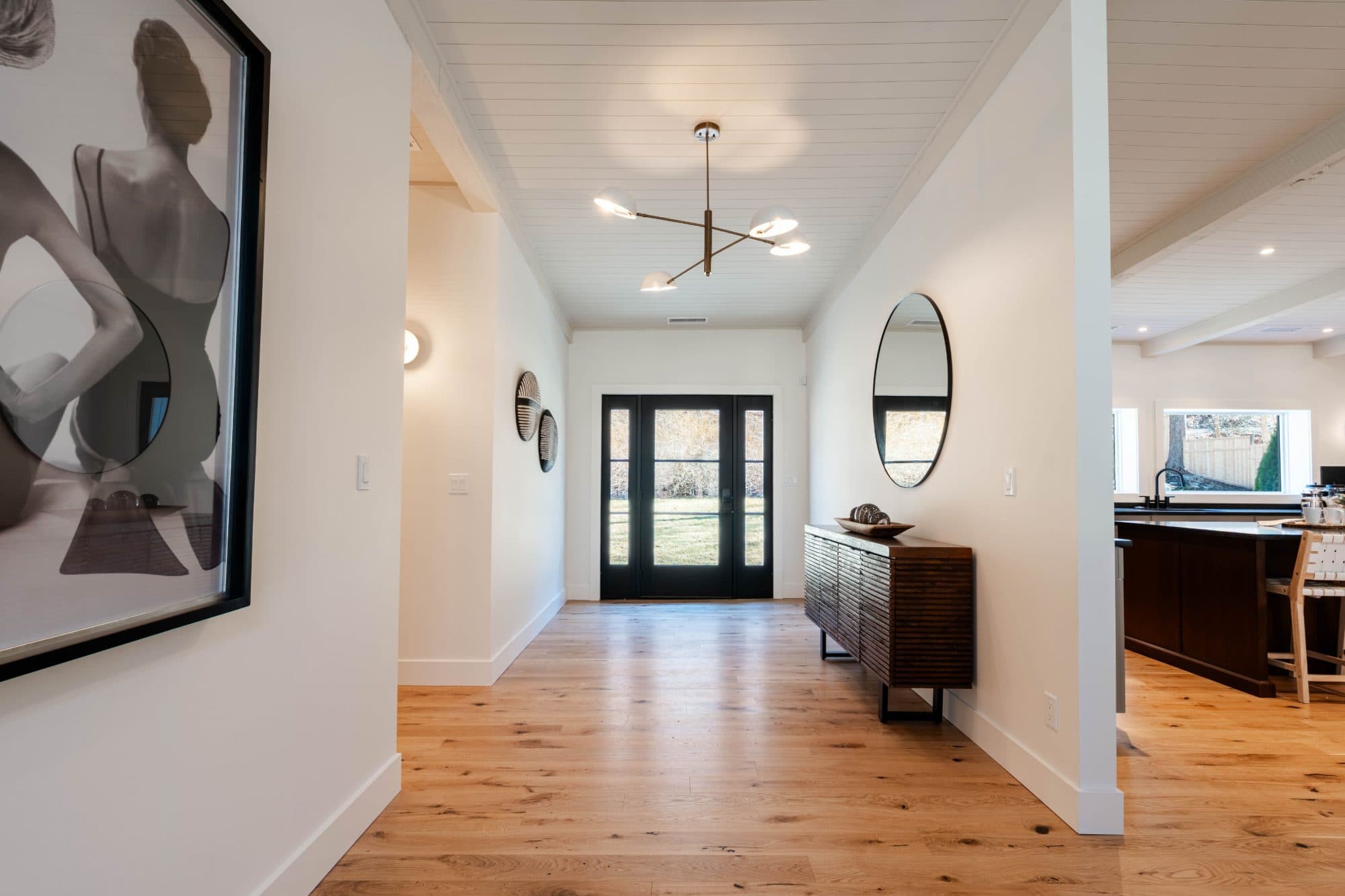 Hawley entry hall — shiplap ceiling, brass fixture, and wide-plank oak floors